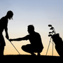Why Golf Lessons Are Essential for Golfers of Every Skill Level - Silhouette of a golfer and golf instructor against a sunset
