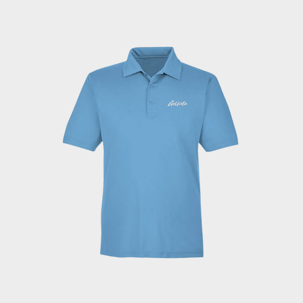 Blue polo shirt with Golfista Logo on a light gray background
