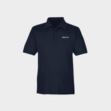 Navy polo shirt with Golfista logo on a light gray background