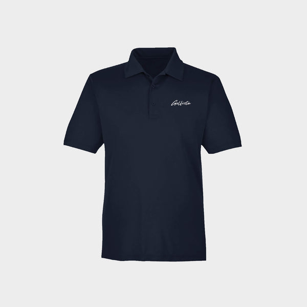 Navy polo shirt with Golfista logo on a light gray background