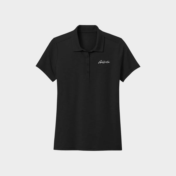 Black polo shirt with Golfista logo on a light gray background