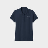 Navy blue polo shirt with Golfista logo on a light gray background